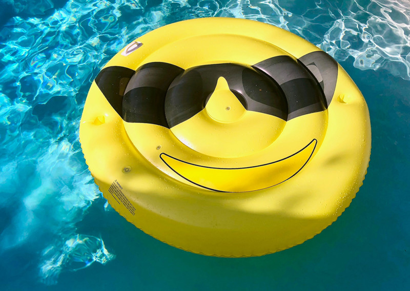 A smiley face pool inflatable showcasing how we can apply our financial plan to THE secret of lasting happiness